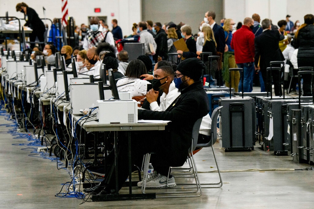 workers counting absentee ballots