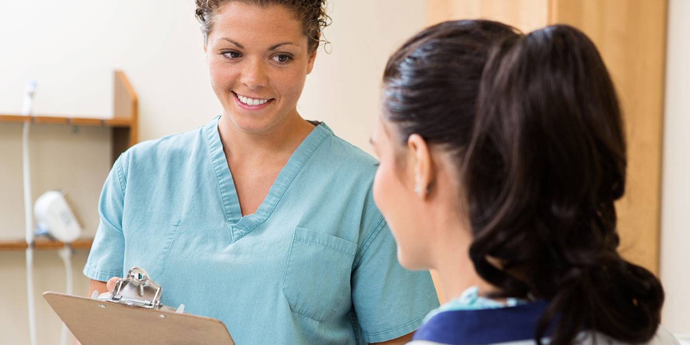 female medical assistant helping patient