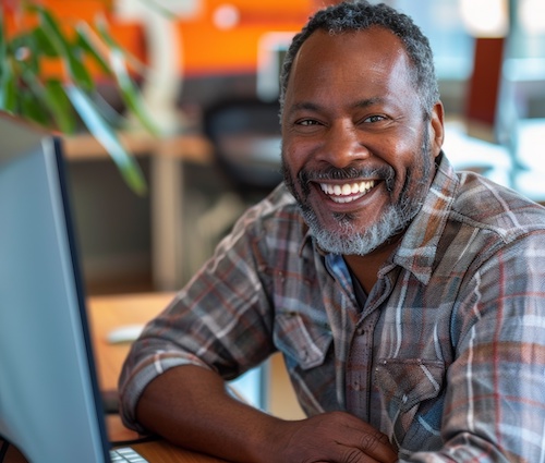 smiling middle-aged man at computer