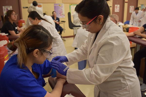 student practicing blood draw