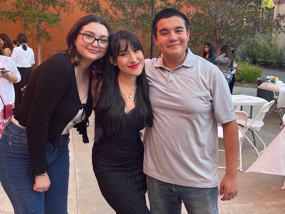 three students arm in arm