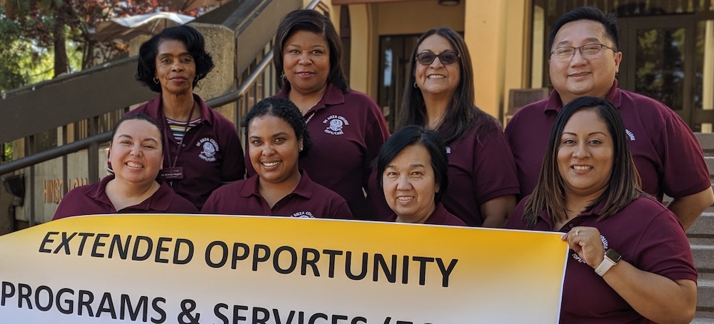 EOPS staff members with banner