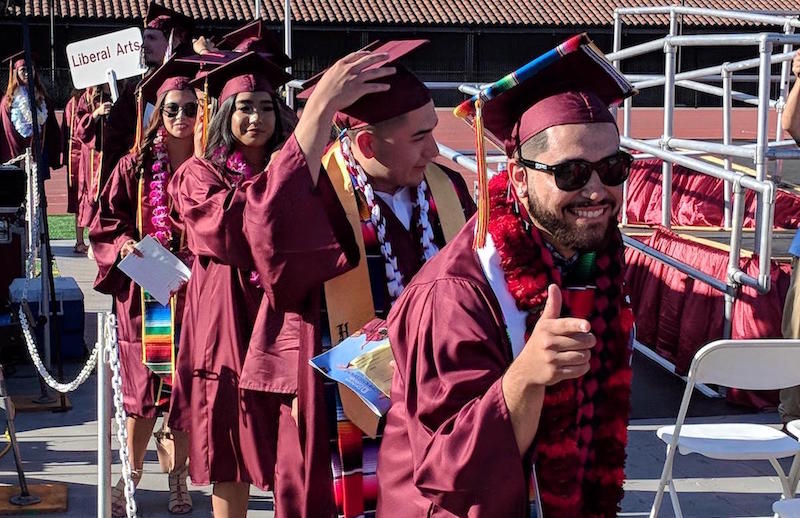 grads giving thumbs up