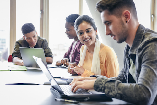 students talking at desk