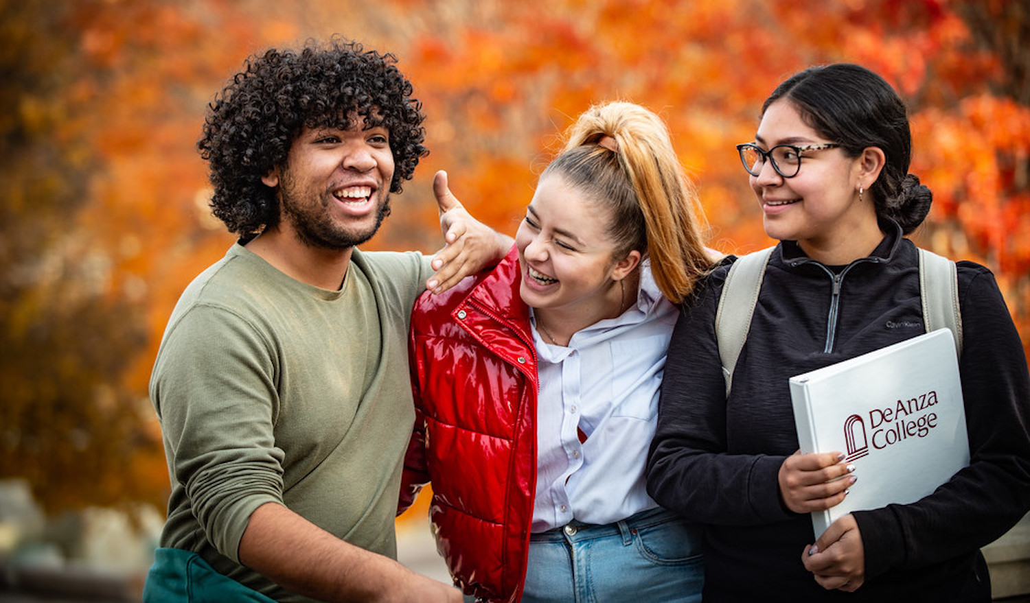 young man laughing with two young women