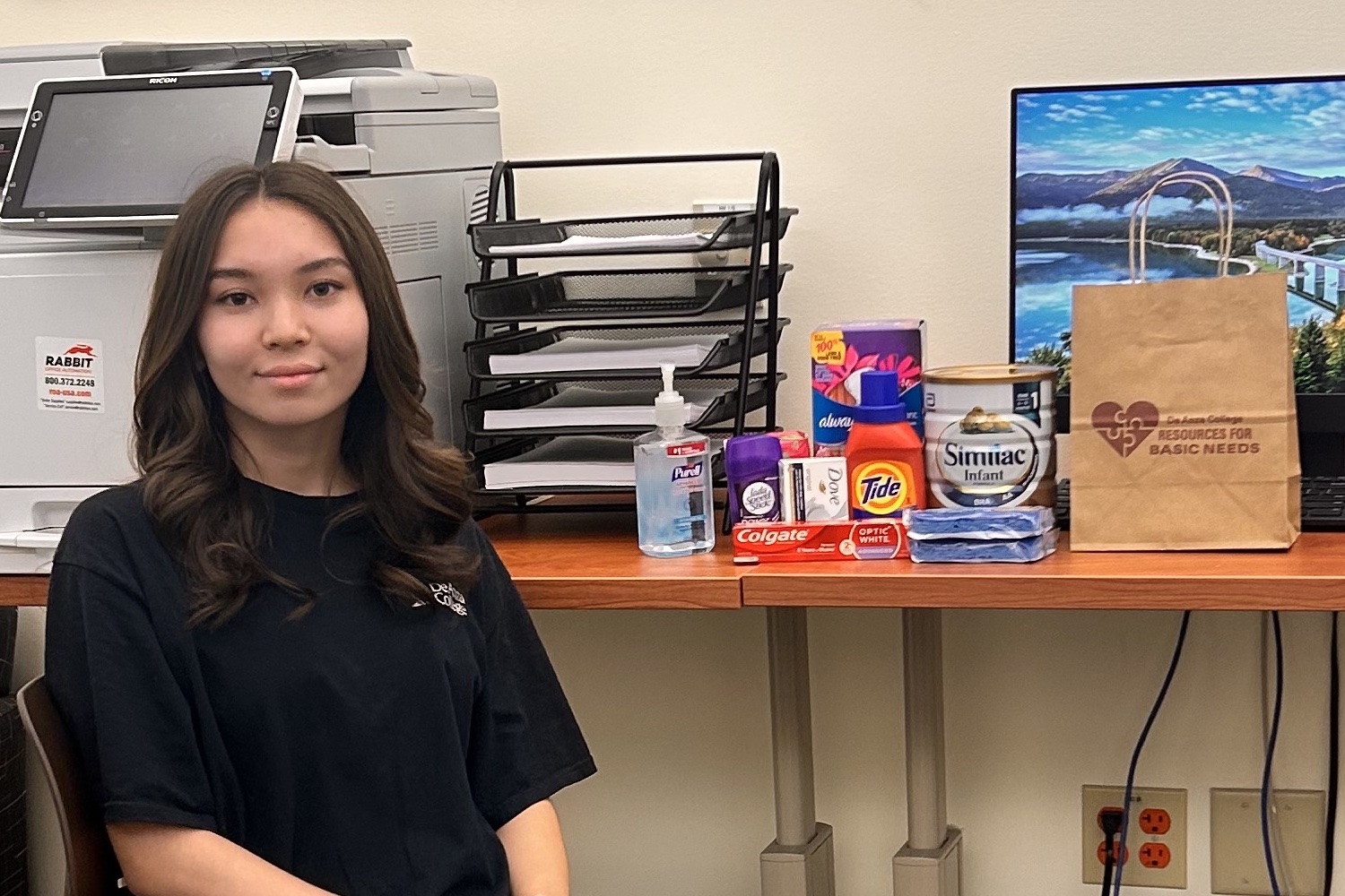 student worker at table with supplies