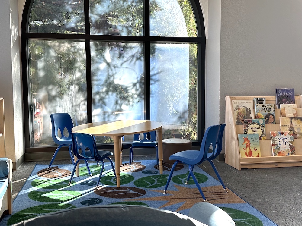 table near sunny window with bookshelf