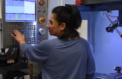 young woman in front of machine