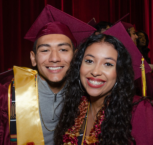 young man and woman in grad gear